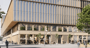 3D-visualisering i grodperspektiv av en stor, modern träbyggnad med uteserveringar och fotgängare på ett torger.